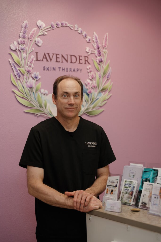 Mike Green, massage therapist at Lavender Skin Therapy, standing in the studio