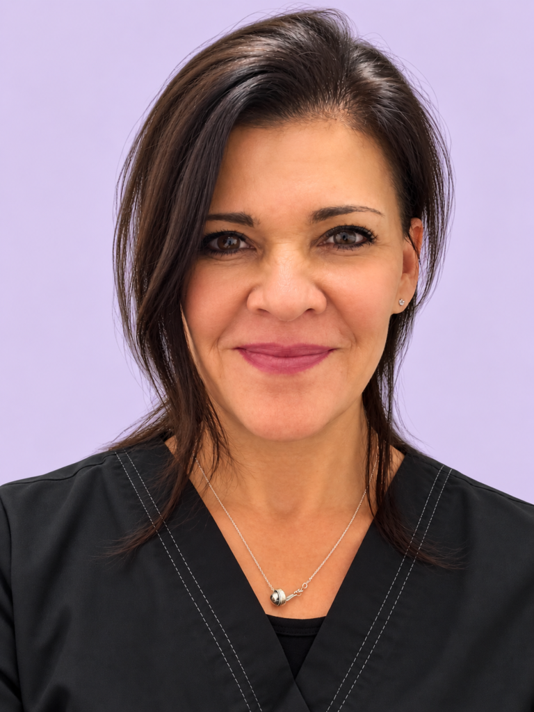 Marie Vegh, RN, smiling in a black top against a lavender background