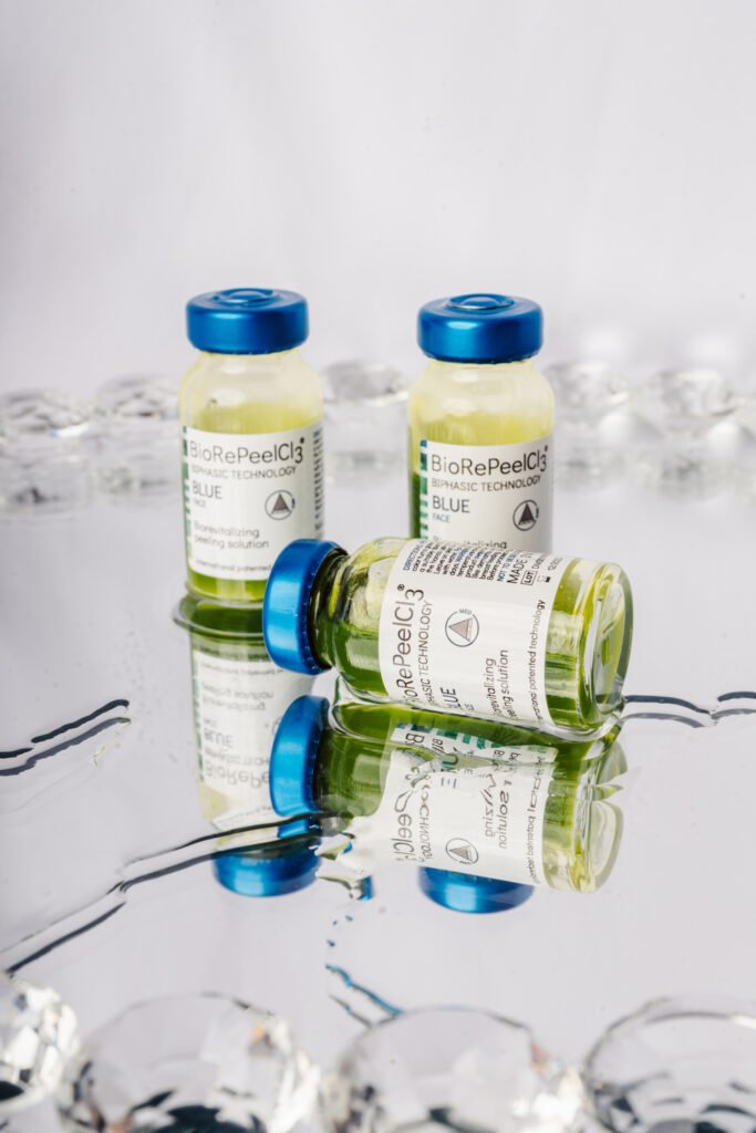 Two BioRePeel treatment bottles on a reflective surface